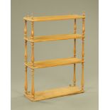 A light oak four tier wall shelf, of Victorian design, with slender baluster turned supports,