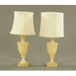 A pair of carved alabaster urn form electric table lamps, with shades, 45 cm high.