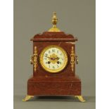 A Victorian variegated marble mantle clock,