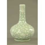 A Chinese Celadon foliate embossed club shaped vase. Height 32 cm.