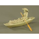 An oriental Celadon porcelain figure, fruit merchant with laden boat, 17 cm high.