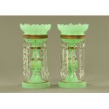 A pair of Victorian green glass lustres, each with faceted glass drops. Height 32 cm.