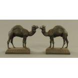 A pair of Victorian black painted cast iron camel pattern implement rests, 27 cm high.