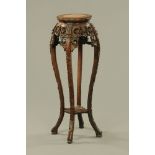 A 19th century Chinese hardwood rouge marble topped jardiniere stand,