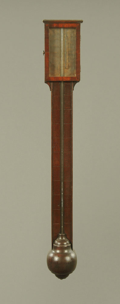 A George III mahogany stick barometer, with paper label exposed tube and turned cistern cover.