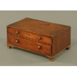 A George III mahogany two drawer cabinet, on ogee feet, 16 cm x 37 cm x 24 cm.