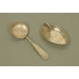 An unusual Indian white metal oval caddy spoon by Hamilton & Co Calcutta with coin handle,