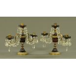 A pair of 19th century cranberry glass two branch candelabra,