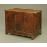 An 18th century panelled oak coffer, with later lid and three panelled front, on stile feet.