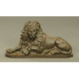 A mid 19th century bronzed cast iron recumbent lion door porter. Height 39 cm, length 73 cm.