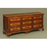 An 18th century oak and mahogany banded dresser base, with quartered and reeded columns,