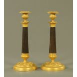 A pair of George IV ormolu and bronzed candlesticks,