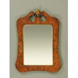 An 18th century figured walnut rectangular wall mirror, of shaped outline,