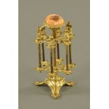 A Victorian ormolu 6 spool reel holder the pin cushion top with leaf moulding,