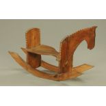 A chip carved and stained elm rocking horse. Height 64 cm, length 108 cm.