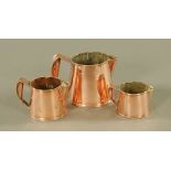 Three Victorian graduated copper jugs, tallest 13 cm.