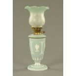 A Wedgwood Jasperware oil lamp, with tinted green glass shade. Height 54 cm.