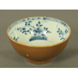 A Chinese blue and white bowl, with cafe au lait exterior. Diameter 15 cm.