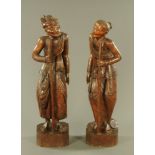 A pair of Chinese carved Huanghuali figures, depicting a man and a woman, in elegant period costume,