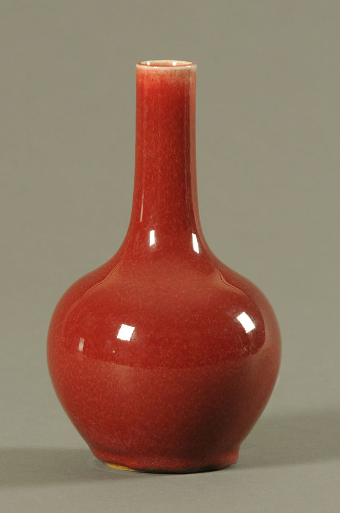 A Chinese Sang de Boeuf porcelain bottle shaped vase (18th/19th century). Height 20 cm.