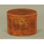 A George III mahogany oval tea caddy, inlaid with floral marquetry. 12 cm high.