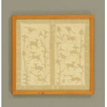 A modern oak framed crewel work embroidery with stylized depictions of game and foliage,