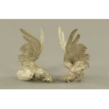 A pair of white metal models of Chinese fighting chickens, 22 cm high.