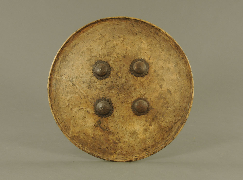 An old eastern papier mache or lacquered circular shield,