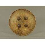 An old eastern papier mache or lacquered circular shield,