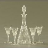 A cut glass liqueur set, comprising small decanter and four glasses. Decanter height 24 cm.