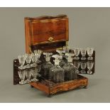 An Early 19th century French rosewood and brass inlaid serpentine fronted liqueur tantalus,