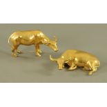 An eastern brass figure of a standing buffalo, 13 cm, together with a figure of a recumbent bull,