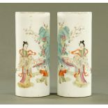 A pair of Chinese cylindrical vases, decorated with figures and fence with square seal mark to base.
