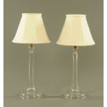A pair of moulded clear glass electric table lamp bases, with shades. 69 cm high.