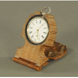 A Black Forest carved wooden watch case, with key wind silver cased watch.