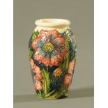 A Moorcroft tube lined pottery "Pheasants Eye" pattern miniature vase.