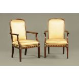 A pair of 19th century French mahogany open arm salon chairs,