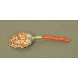 An early 19th century white metal mounted cowrie shell caddy spoon, with red coral terminal.
