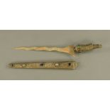 An eastern embossed metal and coloured glass/hardstone set dagger,