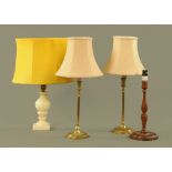 A pair of brass candlesticks, with plain cylindrical sconces and stems on circular bases,