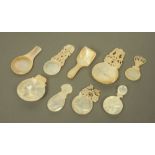 Nine 19th century carved mother of pearl caddy spoons, of varying sizes and designs,