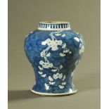 A Chinese blue and white temple vase, decorated with plum blossom on a cracked ice ground,