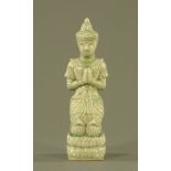 An oriental Celadon porcelain figure, princess kneeling in prayer, 30 cm high.