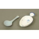 An early 19th century blue and white porcelain oval caddy spoon, with scalloped terminal,