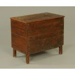 An 18th century oak and stained pine planked coffer or food bin with lifting top, on stile feet.