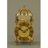 A miniature reproduction brass lantern clock, with spring driven movement.