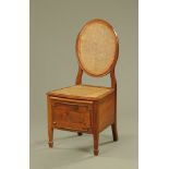 An Edwardian mahogany commode chair of Sheraton style,