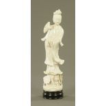 A Chinese blanc de chine porcelain figure of Guan Yin, on ebonised socle, 39 cm.