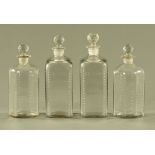 A pair of early 19th century English clear glass square section decanters,