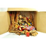 A large box of wooden construction toy parts and components.